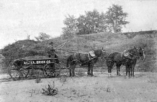 This photograph may be the only extant image of Freedmens Cemetery. Taken in 1899, it depicts an Alexandria Brick Company wagon. Freedmens Cemetery is atop the hill in the background. The brick manufacturer was located to the southwest of the cemetery, and removed clay from the west slope of the hill, reportedly exposing some graves in the early 1890s.